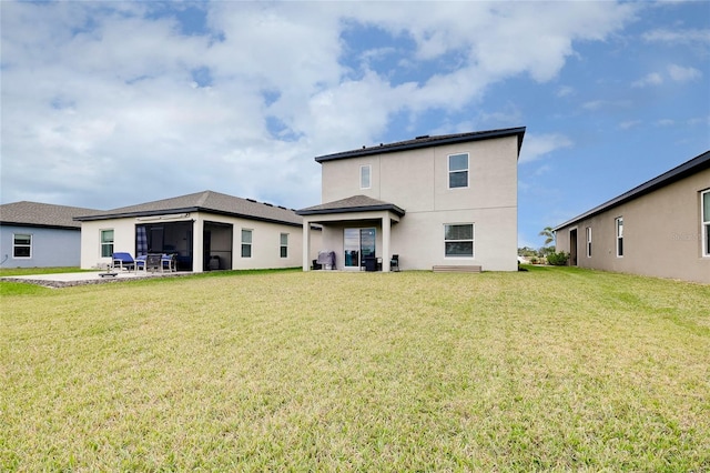 back of house featuring a lawn and a patio area