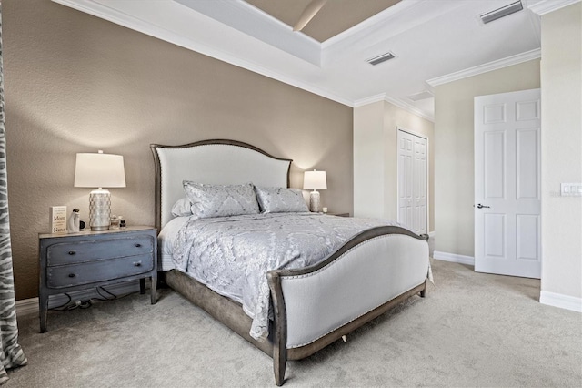 carpeted bedroom featuring crown molding and a closet