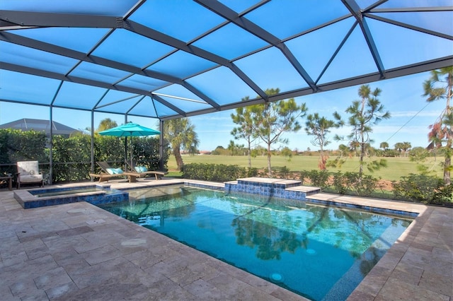 view of pool with a yard, a pool with connected hot tub, glass enclosure, and a patio