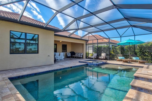 view of pool with an in ground hot tub, a lanai, and a patio