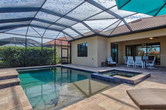 view of swimming pool featuring a patio area, glass enclosure, and an in ground hot tub