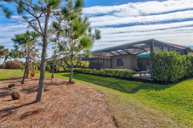 view of yard featuring glass enclosure and a patio area