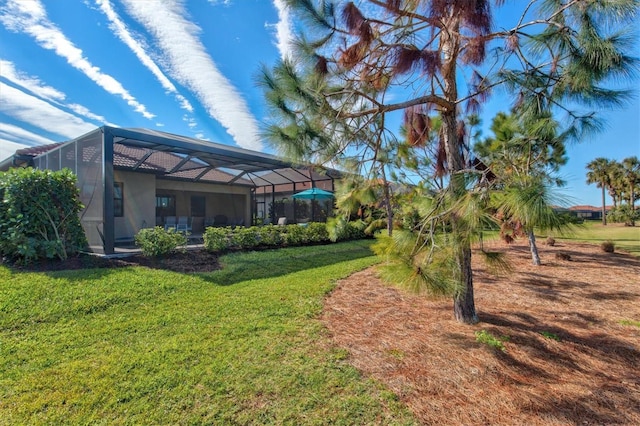 view of yard featuring glass enclosure