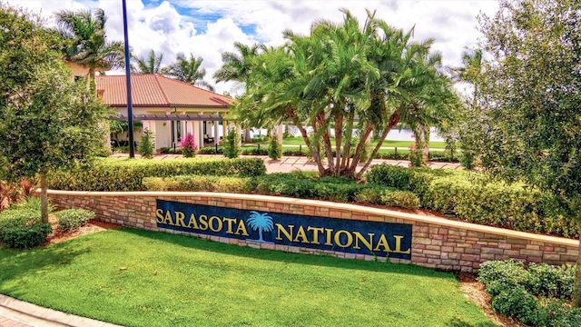 community / neighborhood sign with a lawn