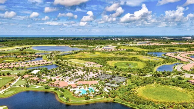 birds eye view of property featuring golf course view and a water view