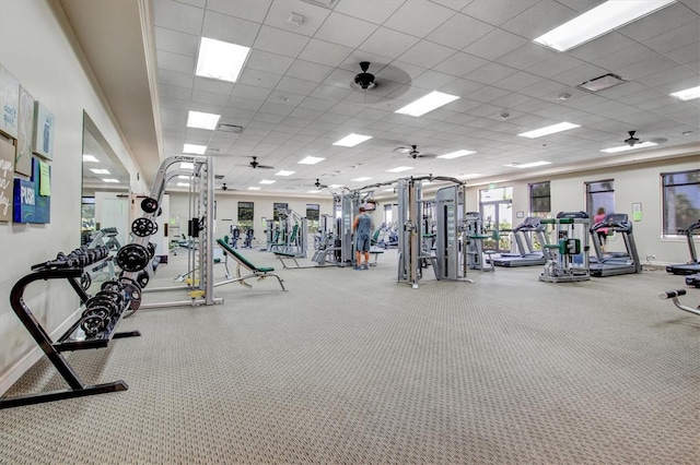 workout area featuring carpet floors, a paneled ceiling, and ceiling fan