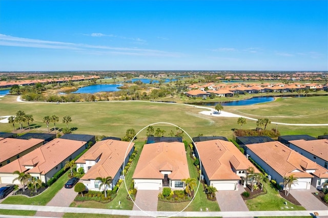 bird's eye view featuring view of golf course, a water view, and a residential view