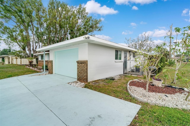 view of home's exterior with a garage and a yard