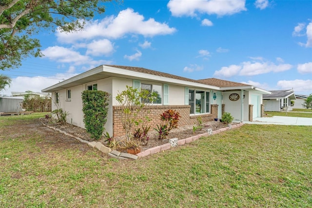 ranch-style home featuring a garage and a front lawn