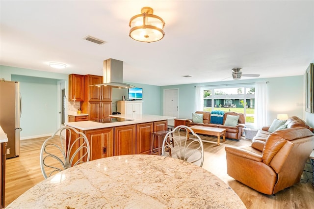 dining space featuring light hardwood / wood-style floors and ceiling fan