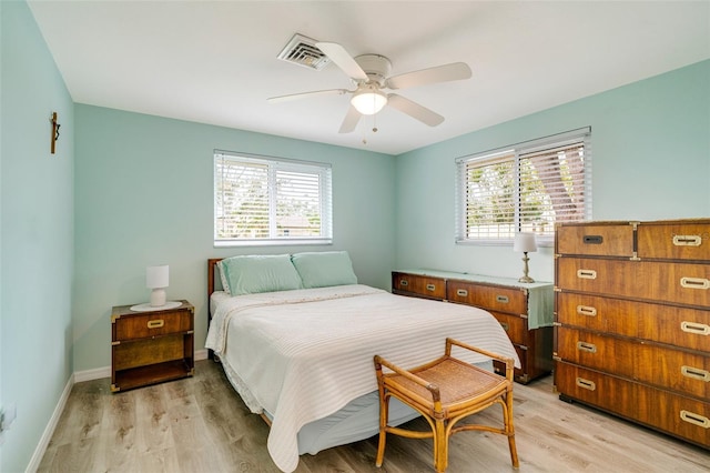 bedroom with light hardwood / wood-style floors, multiple windows, and ceiling fan