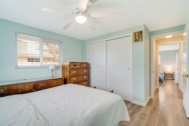 bedroom featuring light wood-type flooring, a closet, and ceiling fan