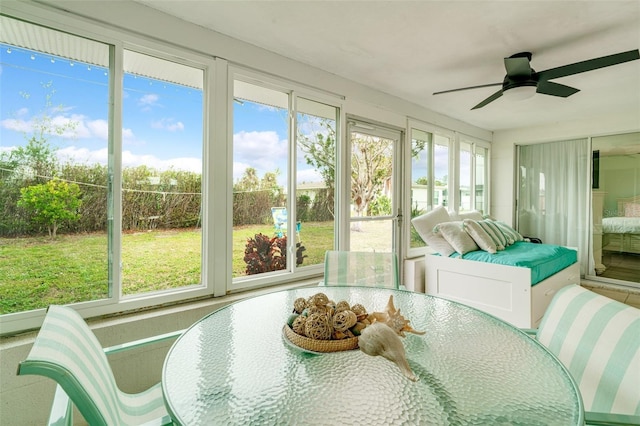 sunroom featuring ceiling fan