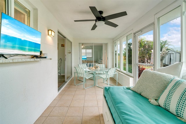 sunroom / solarium featuring ceiling fan