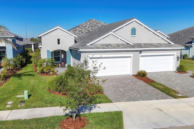 view of front facade with a garage and a front lawn