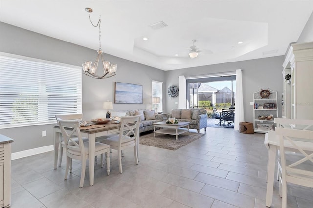 12488 Palatka Dr, Venice, FL 34293 - dining room featuring a raised ceiling, ceiling fan with notable chandelier, and light tile patterned floors