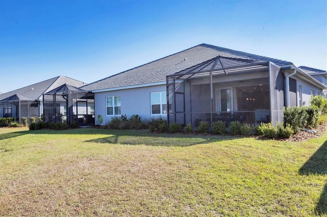 12488 Palatka Dr, Venice, FL 34293 - rear view of property with a lanai and a lawn