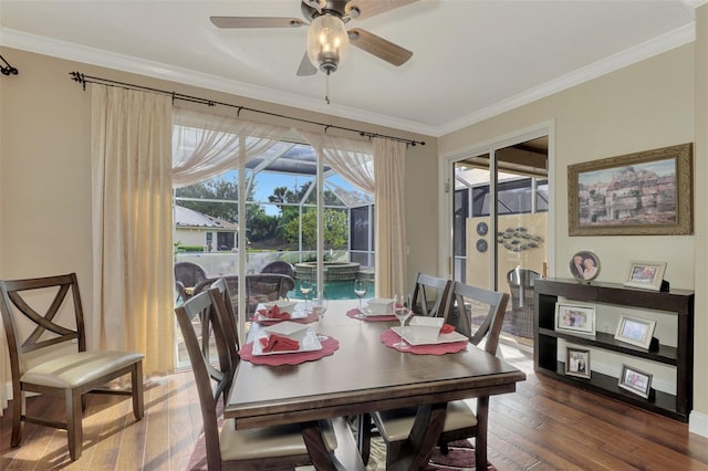 dining room featuring ceiling fan, dark hardwood / wood-style flooring, and crown molding