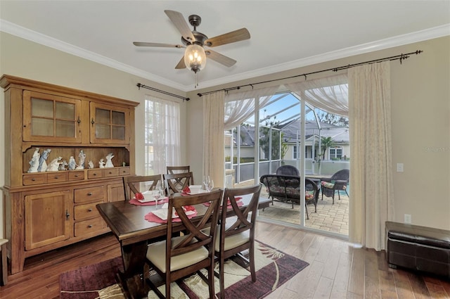 dining area featuring ceiling fan, wood-type flooring, and ornamental molding