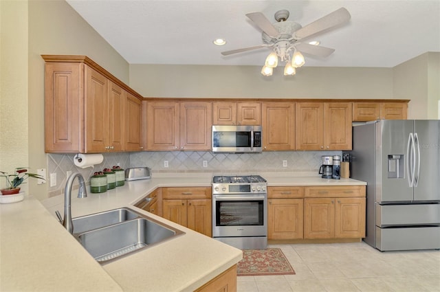 kitchen with ceiling fan, sink, backsplash, and stainless steel appliances