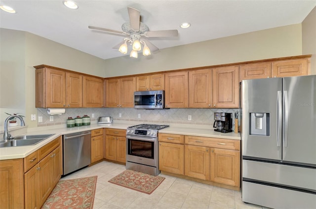 kitchen with ceiling fan, stainless steel appliances, tasteful backsplash, light tile patterned flooring, and sink