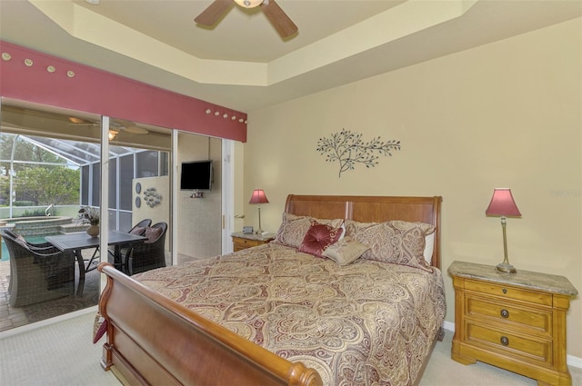 bedroom with ceiling fan, light carpet, a raised ceiling, and access to outside