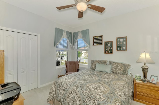 carpeted bedroom with a closet and ceiling fan