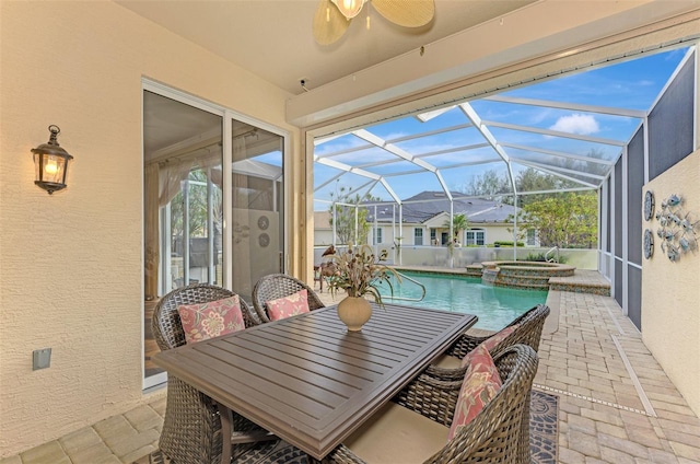 view of patio with a lanai and a swimming pool with hot tub