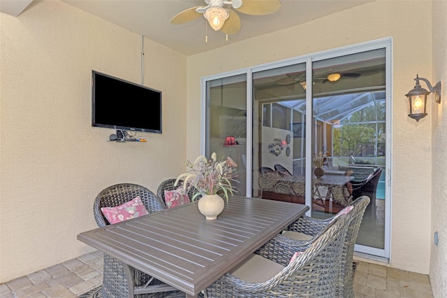 view of patio with ceiling fan and a lanai