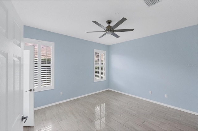 spare room with ceiling fan and a healthy amount of sunlight