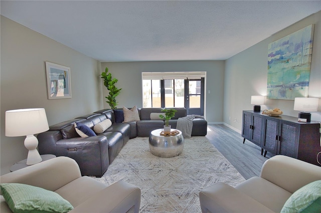 living room featuring a textured ceiling and light wood-type flooring