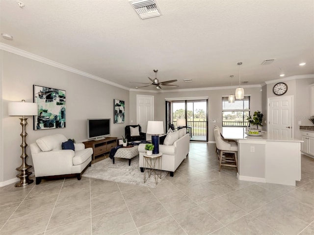 tiled living room with crown molding, a textured ceiling, and ceiling fan