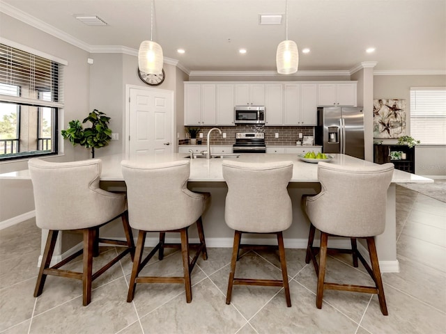 kitchen with white cabinetry, sink, decorative light fixtures, and appliances with stainless steel finishes