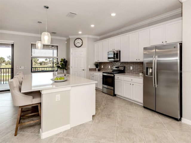 kitchen featuring an island with sink, white cabinets, and appliances with stainless steel finishes