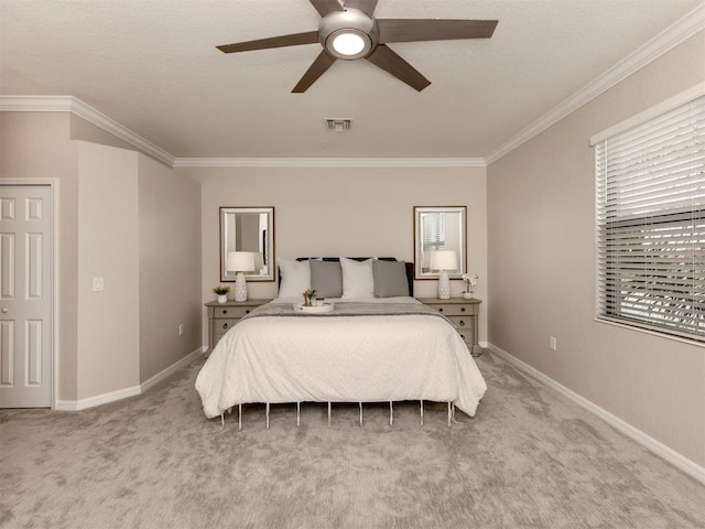 carpeted bedroom with crown molding and ceiling fan