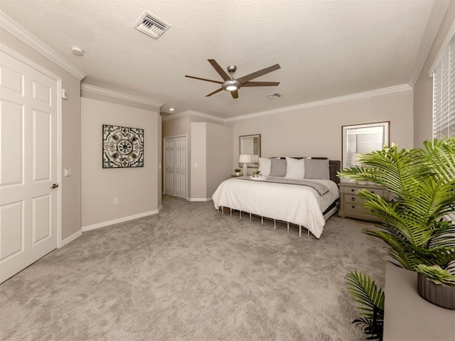 carpeted bedroom featuring crown molding and ceiling fan