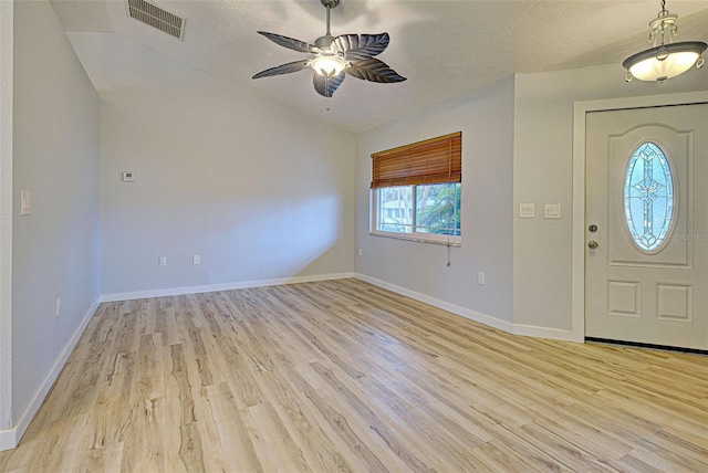 entryway with ceiling fan, light hardwood / wood-style flooring, and a textured ceiling