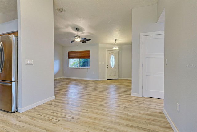 unfurnished living room featuring ceiling fan and light wood-type flooring