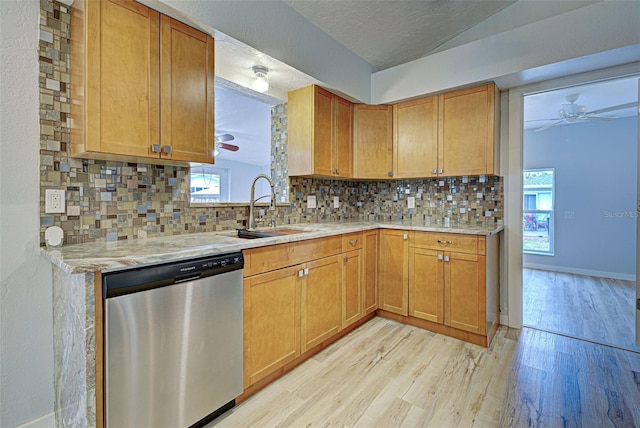 kitchen featuring stainless steel dishwasher, plenty of natural light, decorative backsplash, and a textured ceiling