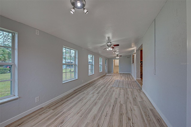 interior space with ceiling fan and light wood-type flooring