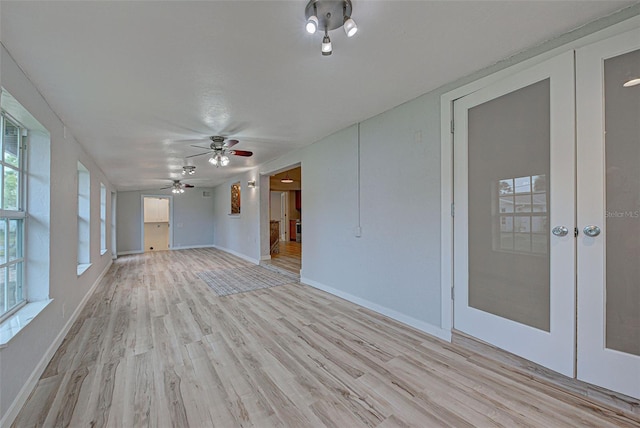 unfurnished room with french doors, ceiling fan, and light hardwood / wood-style flooring