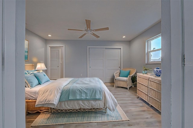 bedroom featuring a closet, ceiling fan, and light wood-type flooring