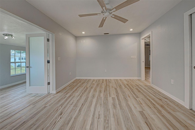 unfurnished room featuring ceiling fan and light hardwood / wood-style floors