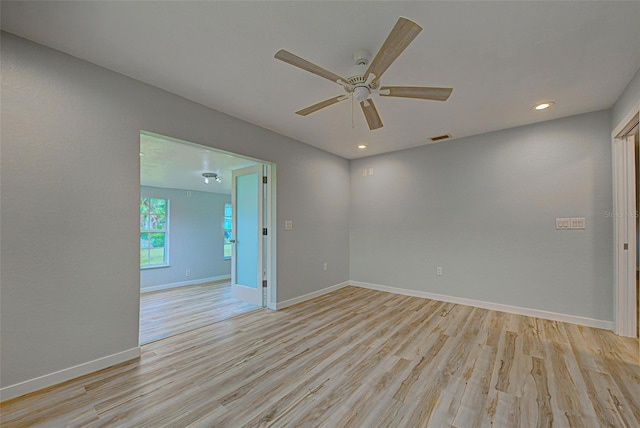 empty room featuring ceiling fan and light hardwood / wood-style floors