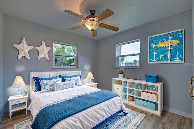 bedroom featuring wood-type flooring and ceiling fan