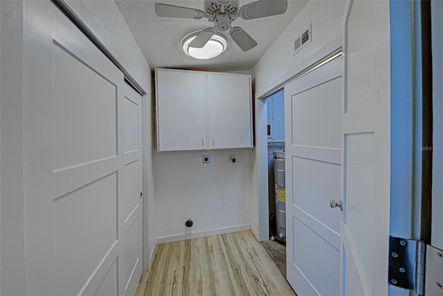 laundry room with ceiling fan, cabinets, hookup for an electric dryer, and light hardwood / wood-style flooring