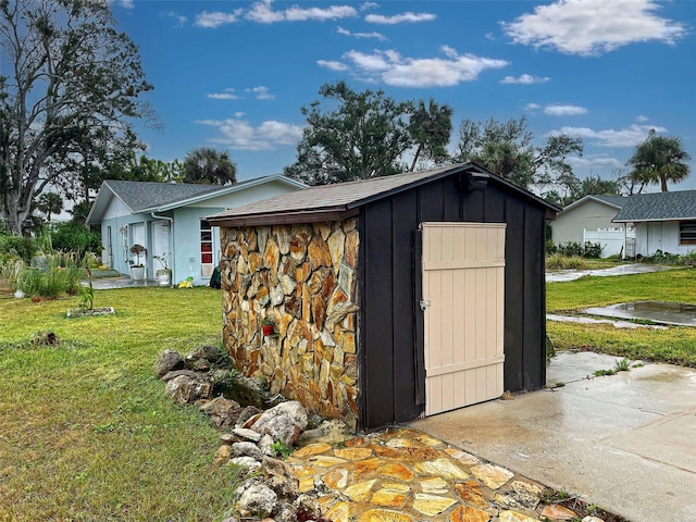 view of outbuilding featuring a lawn