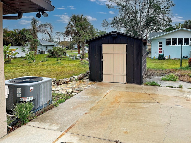 view of outdoor structure featuring cooling unit and a lawn