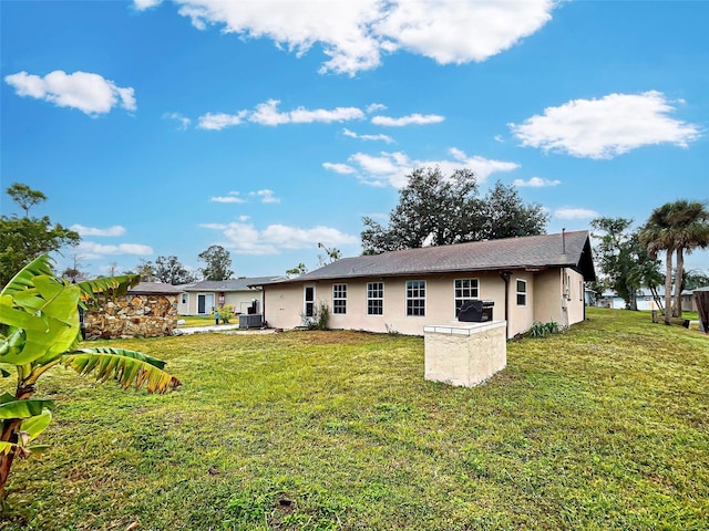 back of house with a lawn