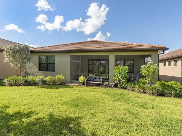 rear view of property with a yard